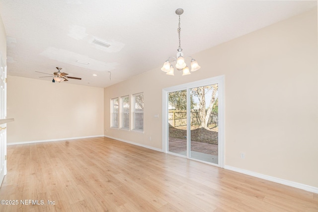 unfurnished dining area featuring visible vents, ceiling fan with notable chandelier, light wood-style flooring, and baseboards