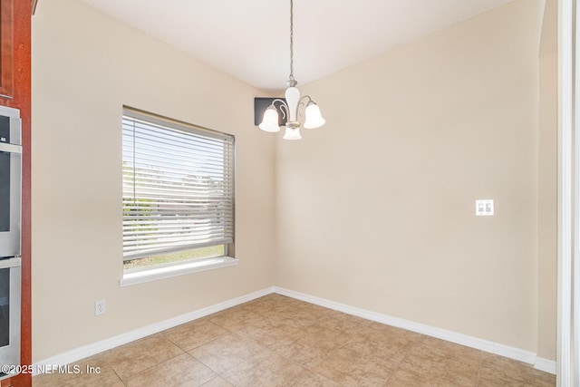 unfurnished room with baseboards, light tile patterned floors, and a notable chandelier