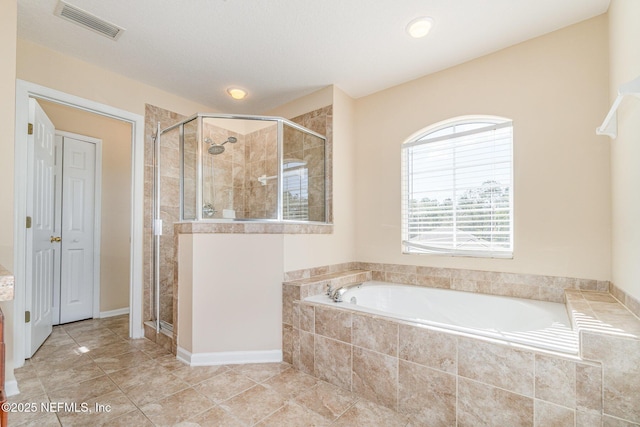 bathroom featuring a garden tub, a shower stall, and visible vents