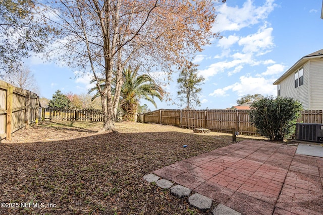 view of yard featuring a fenced backyard, a patio area, and cooling unit