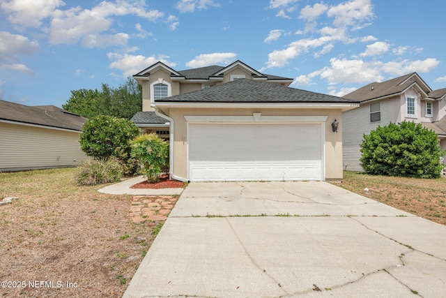 traditional-style house with stucco siding, driveway, and an attached garage