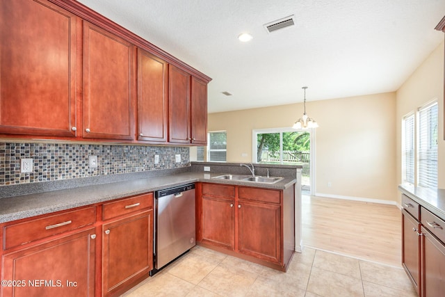 kitchen featuring a sink, dishwasher, tasteful backsplash, and a healthy amount of sunlight
