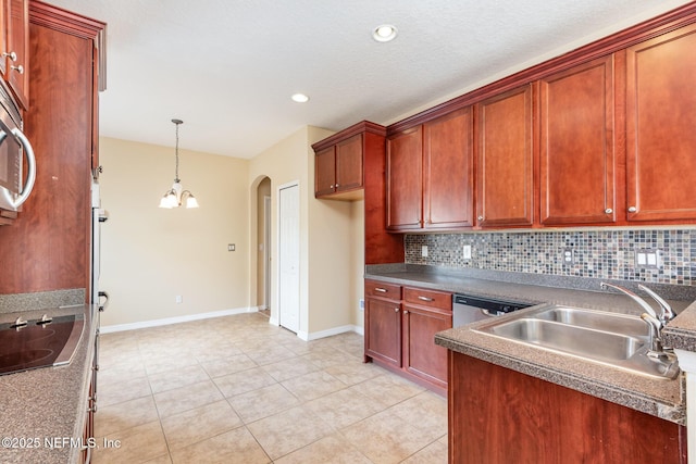 kitchen with arched walkways, a sink, black electric cooktop, and decorative backsplash