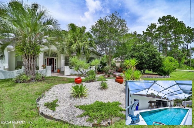 view of pool with a lanai, a yard, and a patio area