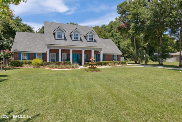 cape cod-style house featuring a front yard