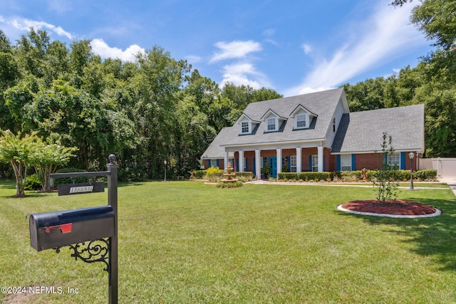 cape cod-style house featuring a front lawn