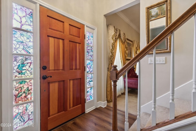 entrance foyer featuring ornamental molding and dark hardwood / wood-style flooring