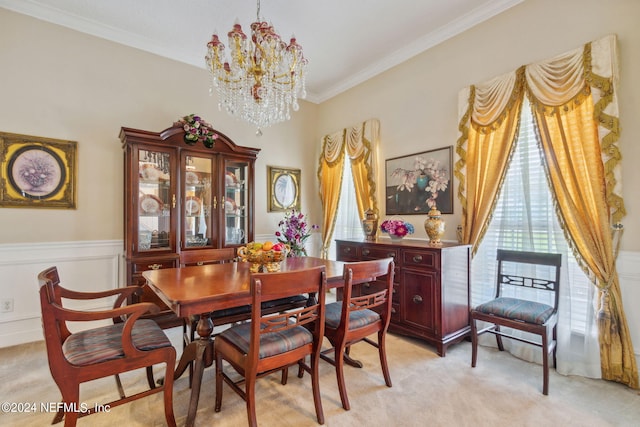 dining room with light carpet, ornamental molding, and an inviting chandelier