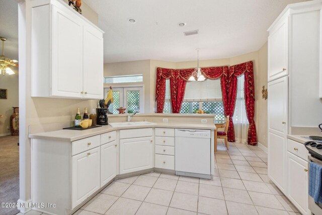 kitchen with light tile patterned flooring, white dishwasher, sink, and white cabinets