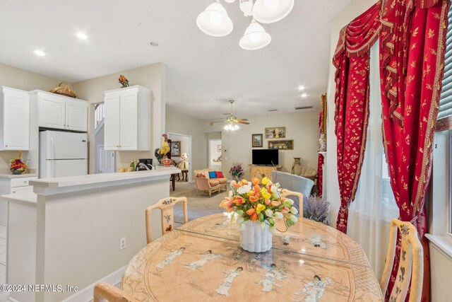 carpeted dining room featuring ceiling fan