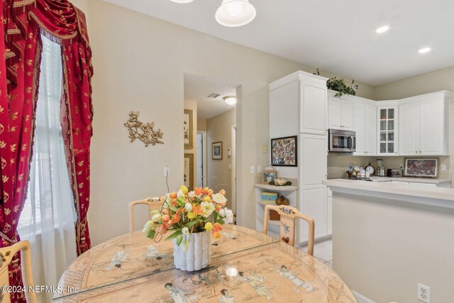 dining area featuring light tile patterned floors