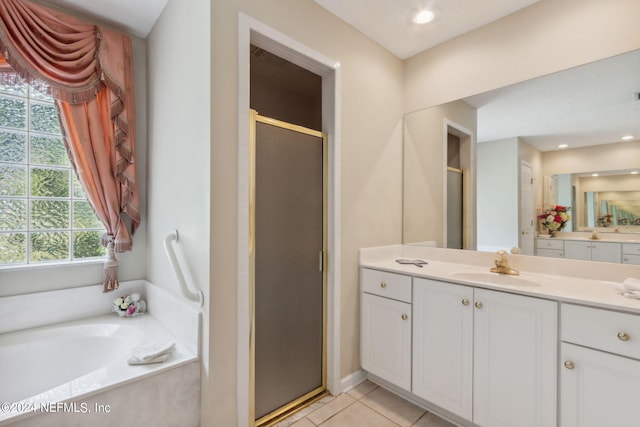 bathroom featuring tile patterned floors, separate shower and tub, and vanity