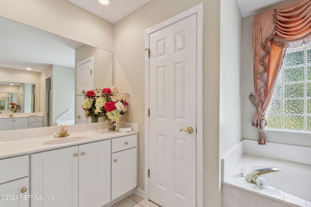 bathroom featuring vanity, a bathtub, and tile patterned floors