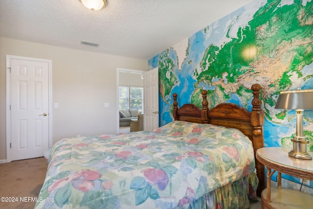 bedroom with carpet flooring and a textured ceiling