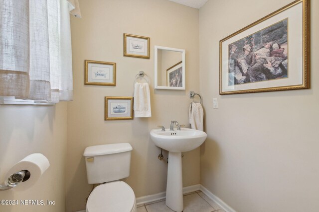 bathroom with tile patterned flooring and toilet