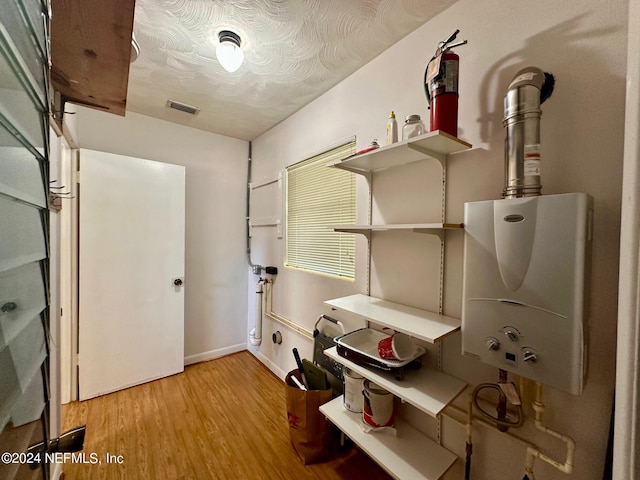 utility room featuring water heater