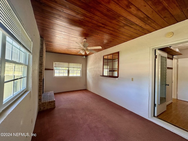 unfurnished room featuring carpet flooring, ceiling fan, and wood ceiling