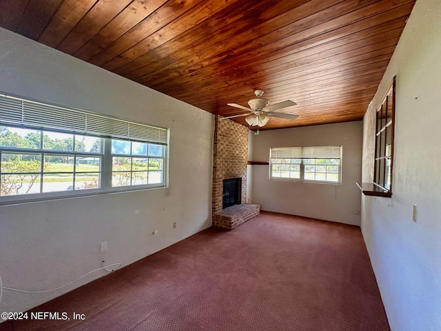 unfurnished living room with ceiling fan, wooden ceiling, a fireplace, and carpet floors