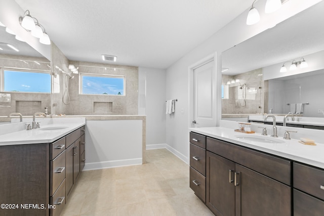 bathroom with tile patterned flooring and dual bowl vanity