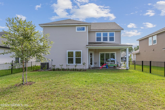 back of house featuring a yard, a patio, and central AC