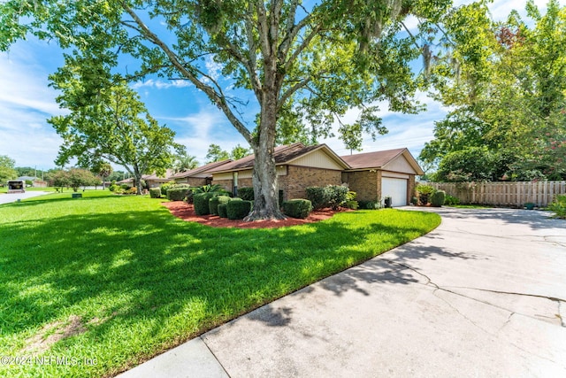 ranch-style house with a garage and a front lawn