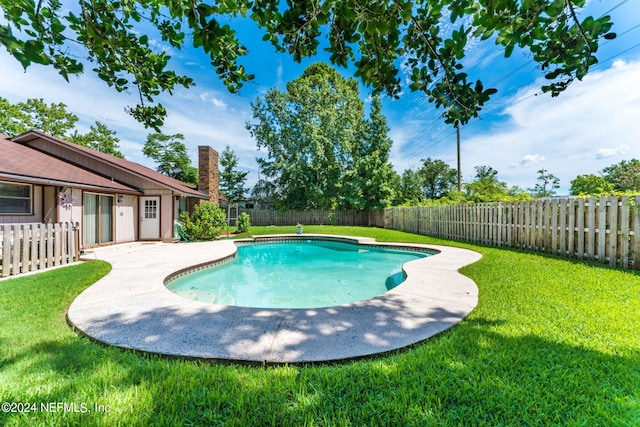 view of pool featuring a yard and a patio