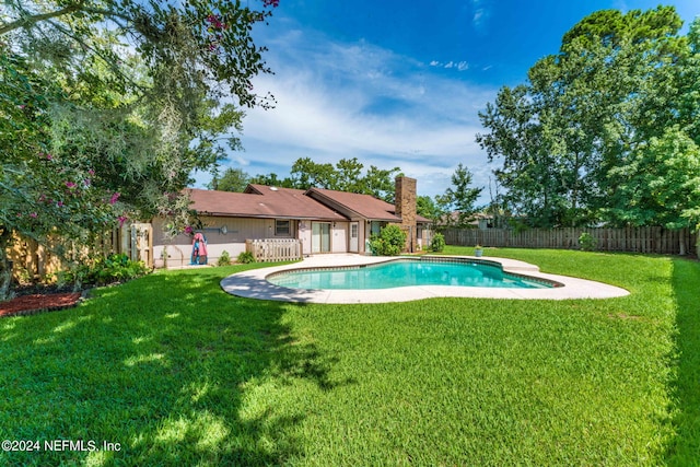 view of swimming pool with a patio area and a lawn