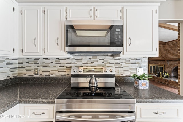 kitchen featuring backsplash, white cabinetry, and stainless steel appliances