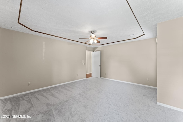 carpeted spare room with ceiling fan and a textured ceiling