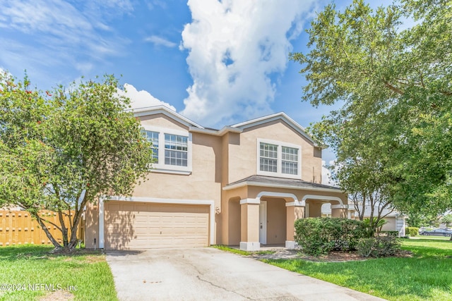 view of front of property with a front lawn and a garage