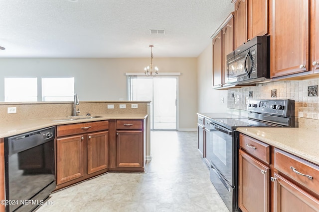 kitchen with sink, a wealth of natural light, black appliances, and a notable chandelier