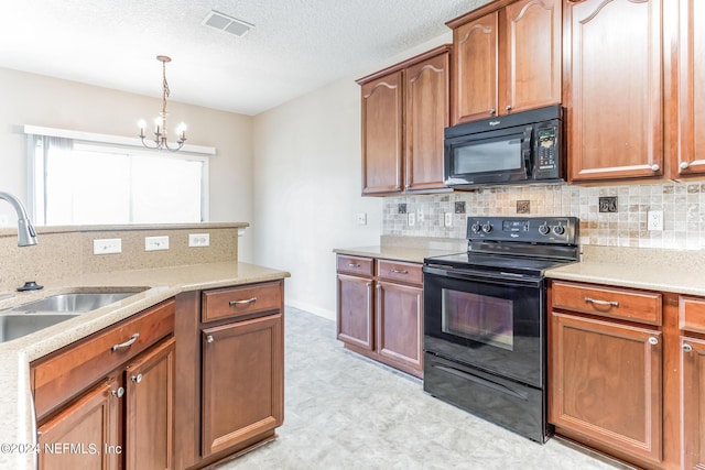 kitchen featuring a chandelier, black appliances, hanging light fixtures, sink, and backsplash