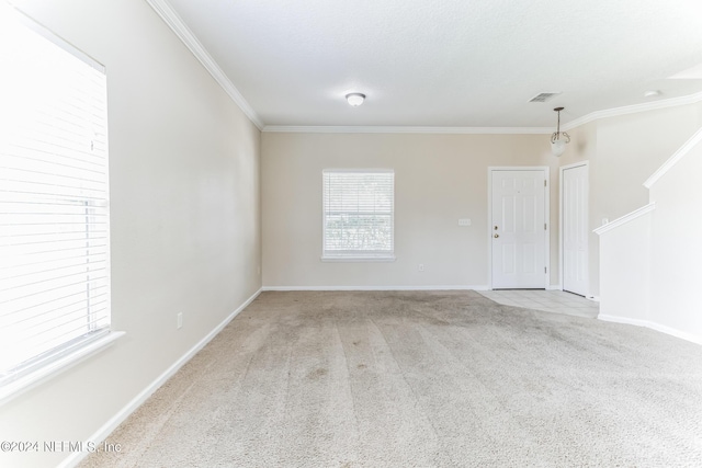 unfurnished room featuring ornamental molding and light colored carpet