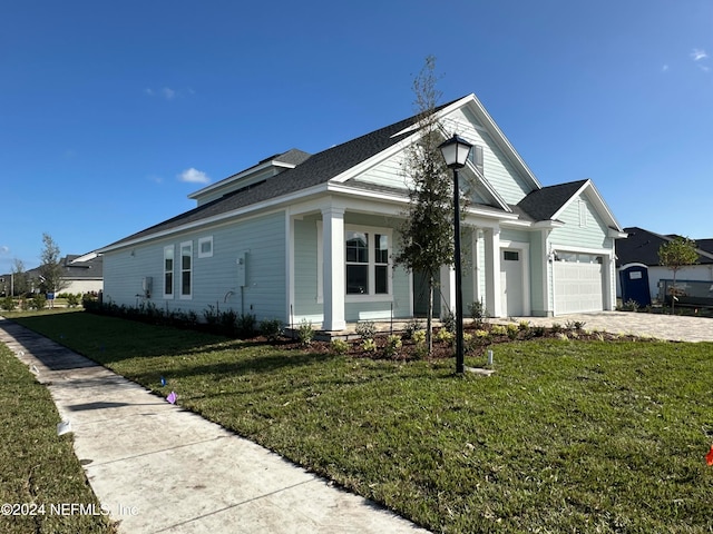 view of front of home featuring a garage and a front lawn