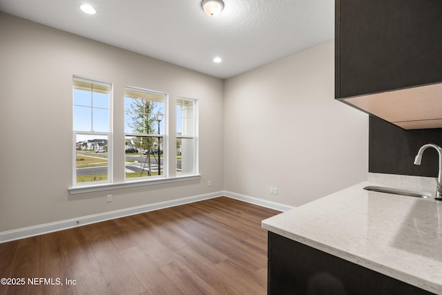 interior space featuring recessed lighting, baseboards, and wood finished floors