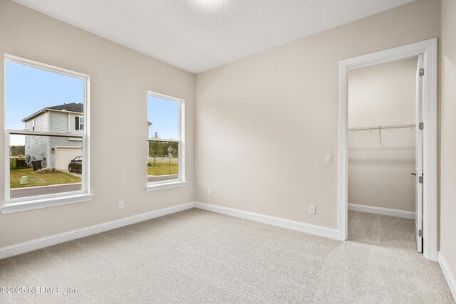 carpeted spare room with baseboards