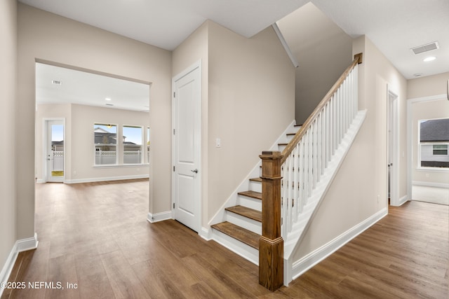 stairs with visible vents, recessed lighting, baseboards, and wood finished floors