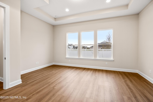 unfurnished room with recessed lighting, baseboards, and wood finished floors