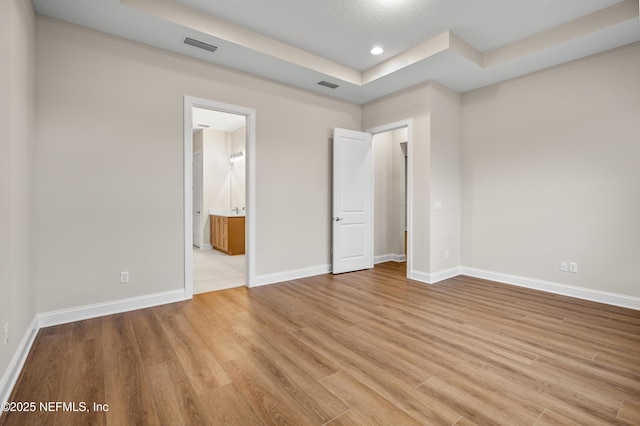 unfurnished bedroom with recessed lighting, light wood-style floors, visible vents, and baseboards