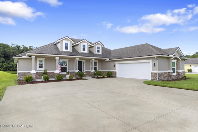 view of front of property featuring a garage and covered porch