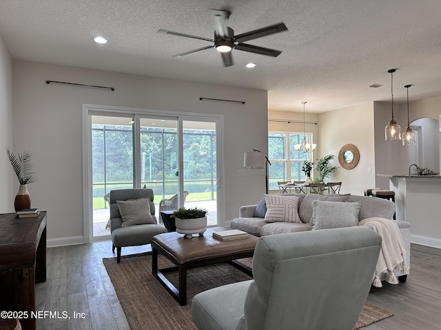 95014 Brookhill Pl, Fernandina Beach, FL 32034 - living room with a textured ceiling, a chandelier, wood finished floors, recessed lighting, and a ceiling fan