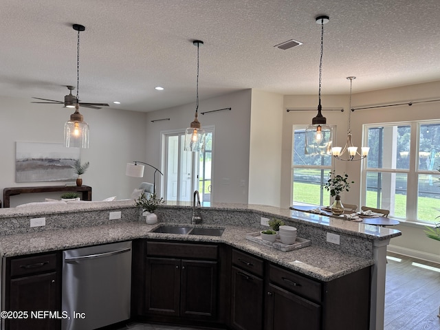 95014 Brookhill Pl, Fernandina Beach, FL 32034 - kitchen featuring dishwasher, wood finished floors, healthy amount of natural light, light stone counters, and a textured ceiling