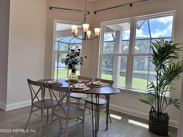 95014 Brookhill Pl, Fernandina Beach, FL 32034 - dining space featuring wood finished floors, a chandelier, and a water view