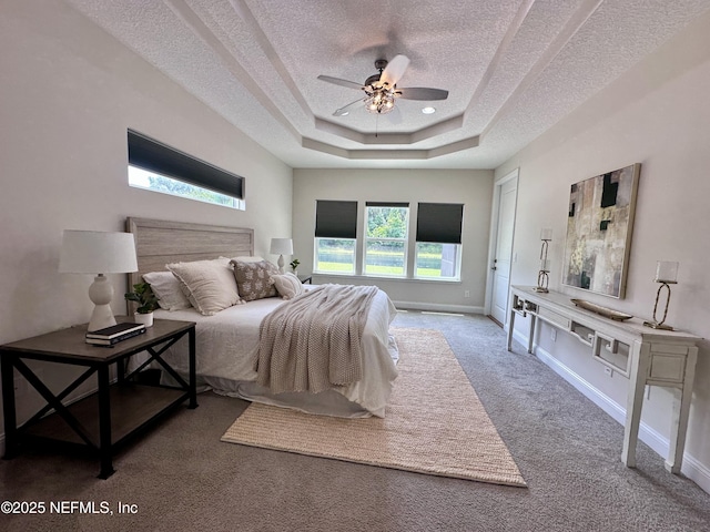 95014 Brookhill Pl, Fernandina Beach, FL 32034 - bedroom featuring a textured ceiling, carpet flooring, a raised ceiling, and a ceiling fan