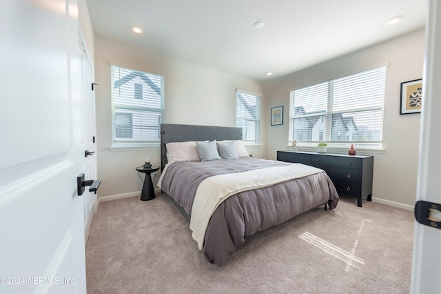 bedroom featuring light carpet