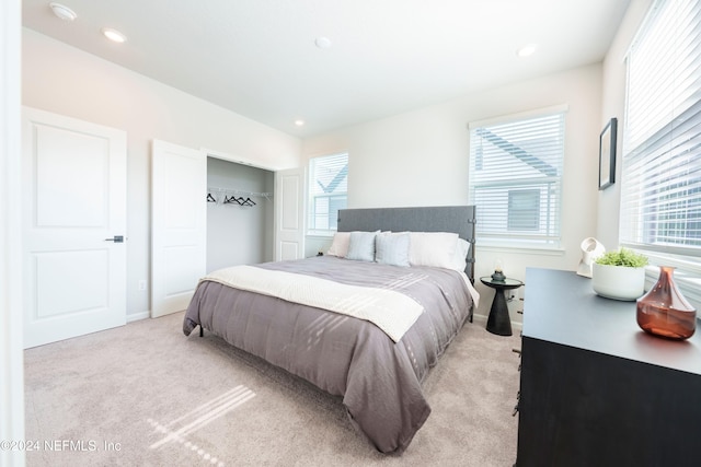 bedroom featuring light carpet