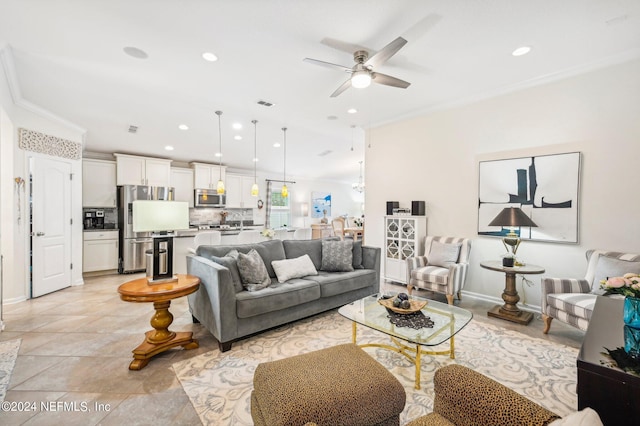 living room with ceiling fan and ornamental molding