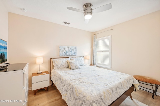 bedroom with ceiling fan and light hardwood / wood-style flooring