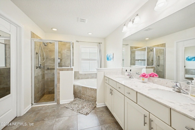 bathroom with vanity and separate shower and tub