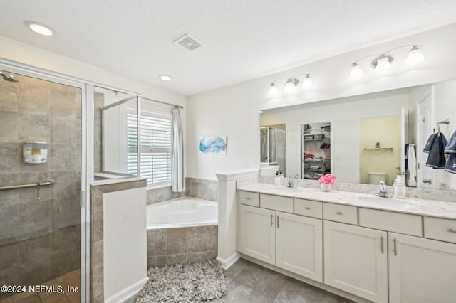 full bathroom featuring toilet, vanity, and separate shower and tub